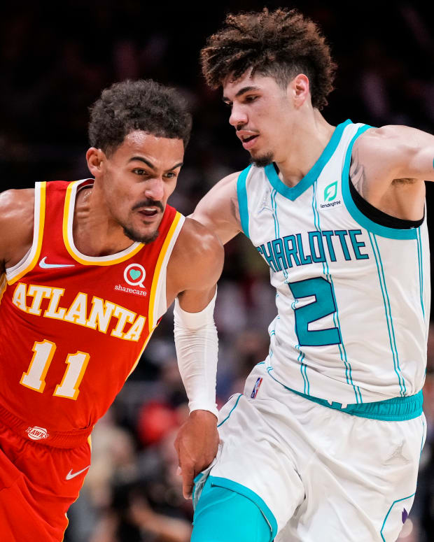 Atlanta Hawks guard Trae Young (11) dribbles the ball against Charlotte Hornets guard LaMelo Ball (2) during the second half at State Farm Arena.