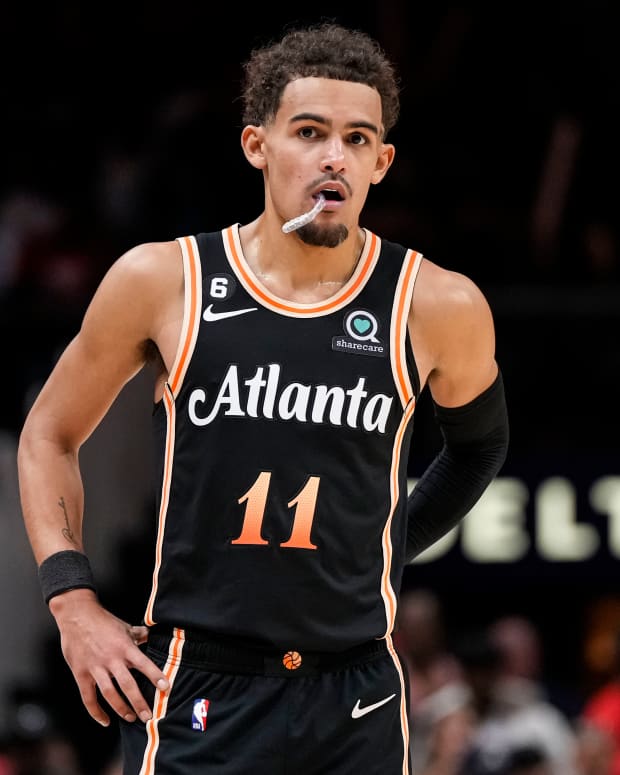 Trae Young stands at foul line during a game.