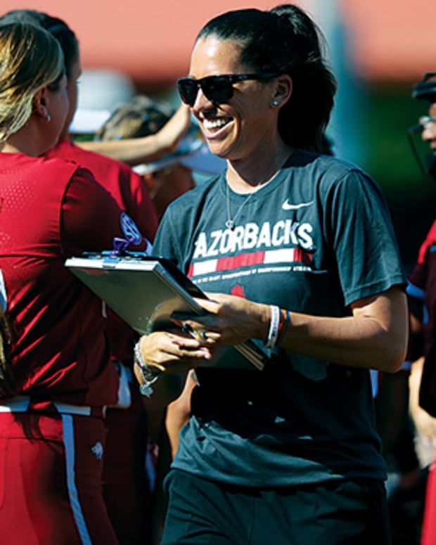 Arkansas softball coach Courtney Deifel heads over for her postgame interview with ESPN following the Razorbacks' 4-0 shutout of Missouri in the SEC Tournament championship game. Deifel is the first coach in Arkansas history to have an overall winning record at 225-125.