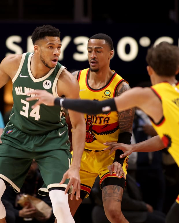 Milwaukee Bucks forward Giannis Antetokounmpo (34) is guarded by Atlanta Hawks forward John Collins (20), guard Trae Young (11), and forward De'Andre Hunter (12) during the first quarter at State Farm Arena.
