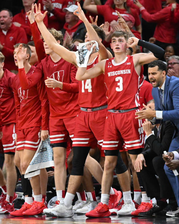 The bench for Wisconsin men's basketball gets fired up after a made three.