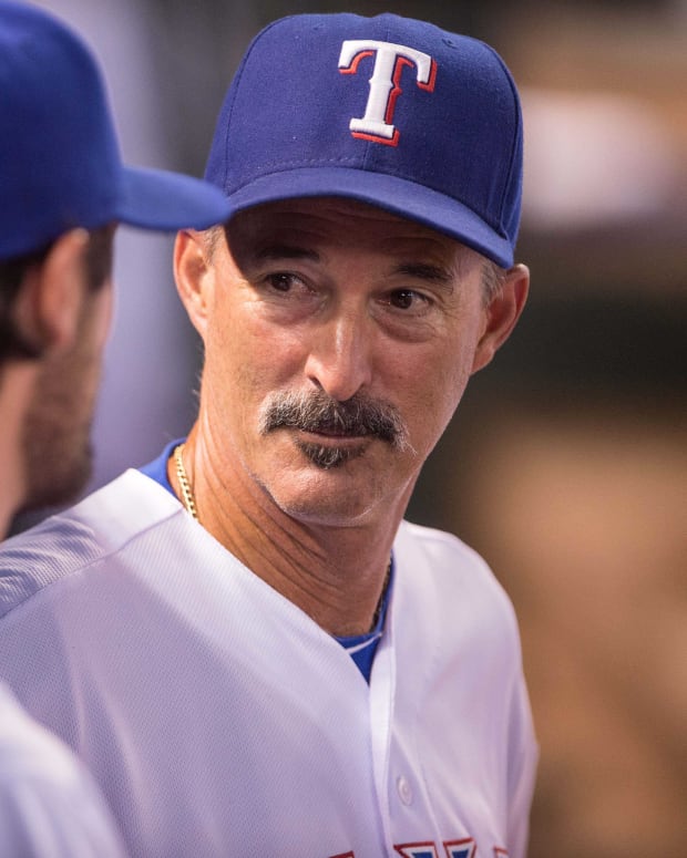 Jul 31, 2015; Arlington, TX, USA; Texas Rangers pitching coach Mike Maddux (31) talks with starting pitcher Cole Hamels (35) during the game at Globe Life Park in Arlington. The Rangers defeated the Giants 6-3. Mandatory Credit: Jerome Miron-USA TODAY Sports