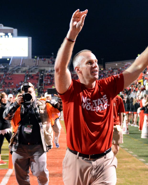 Wolfpack coach Dave Doeren acknowledges the crowd during a night game at Carter-Finley Stadium