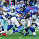 New York Giants running back Saquon Barkley (26) rushes against Dallas Cowboys safety Jayron Kearse (27) in the second half at MetLife Stadium. The Giants fall to the Cowboys, 21-6, on Sunday, Dec. 19, 2021, in East Rutherford.