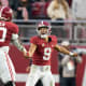 Alabama Crimson Tide quarterback Bryce Young (9) celebrates with Alabama Crimson Tide offensive lineman Javion Cohen (70) after a touchdown against the Auburn Tigers during the first half at Bryant-Denny Stadium.