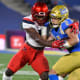 Arizona Wildcats defensive back Christian Roland-Wallace (4) tackles UCLA Bruins wide receiver Kyle Philips (2) during a third quarter running play at the Rose Bowl.