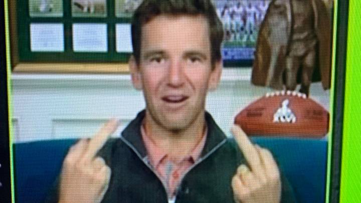 Eli Manning displaying both middle fingers during the 2021 ManningCast broadcast
