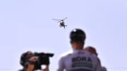 Helicopter Camera Following Cycling Race Uncovers Rooftop Marijuana Farm