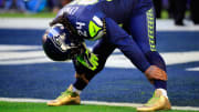 Marshawn Lynch sports gold cleats for Super Bowl warmups