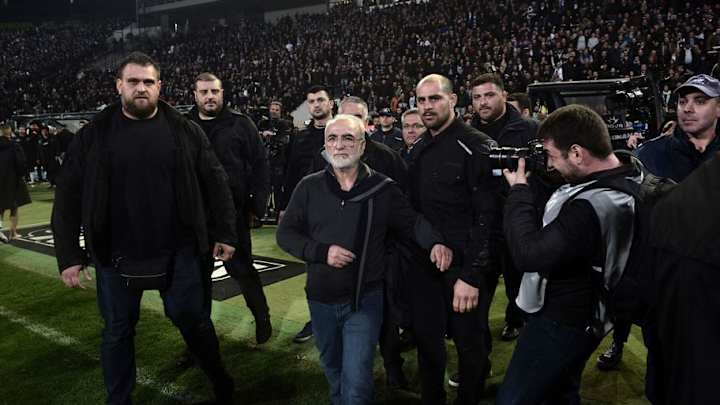 PHOTO: PAOK Owner Storms Pitch Armed With Hand Gun During Rival Encounter With AEK Athens