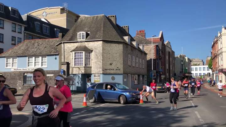 Watch: Woman Drives Car Into Runners' Path During Half Marathon Watch: Woman Drives Car Into Runners' Path During Half Marathon