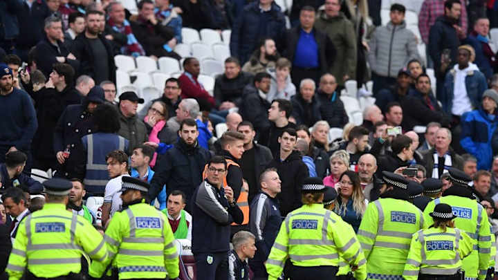 PHOTO: Children Take Shelter on Burnley Bench As Supporters Cause Chaos at West Ham PHOTO: Children Take Shelter on Burnley Bench As Supporters Cause Chaos at West Ham