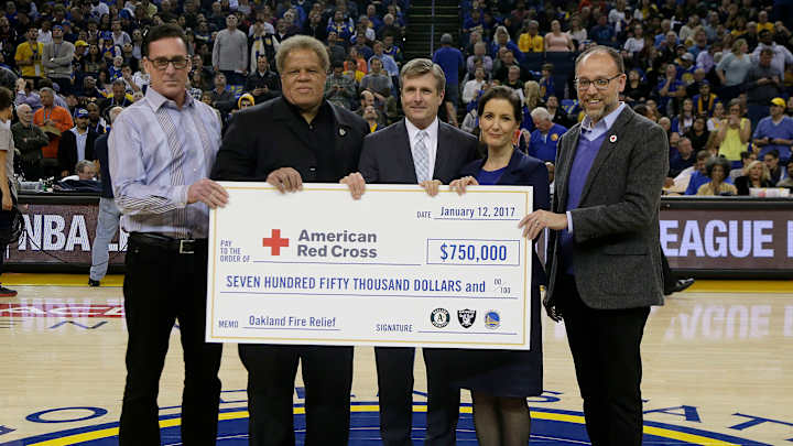 Warriors, A's, Raiders present check to Oakland fire relief