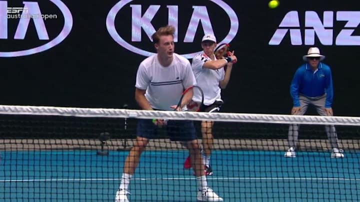 Dude takes tennis ball to the noggin from his doubles partner