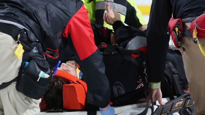 Hurricanes goalie Eddie Lack taken from ice on stretcher after collision