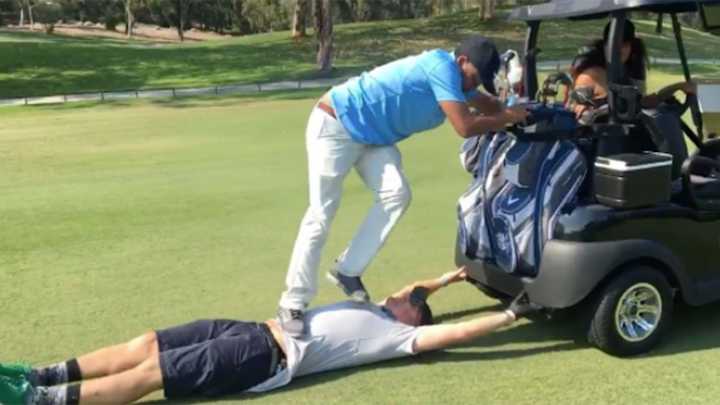 Watch: Guy dragged by golf cart gets drink poured in his mouth