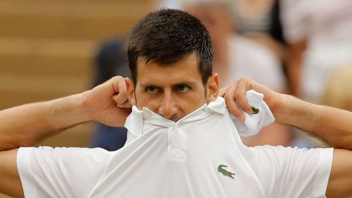 Djokovic reaches Wimbledon quarters with injured shoulder