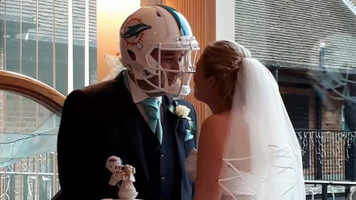 Wife buys husband a Miami Dolphins helmet to wear during their wedding Wife buys husband a Miami Dolphins helmet to wear during their wedding