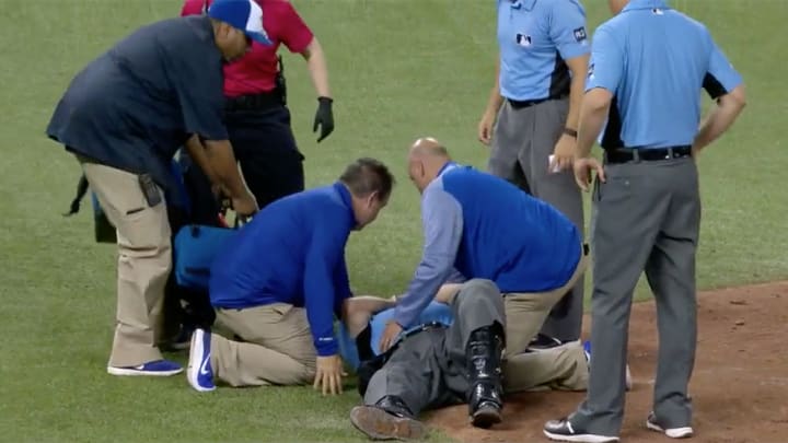 Umpire Dale Scott carted off field after being struck in mask