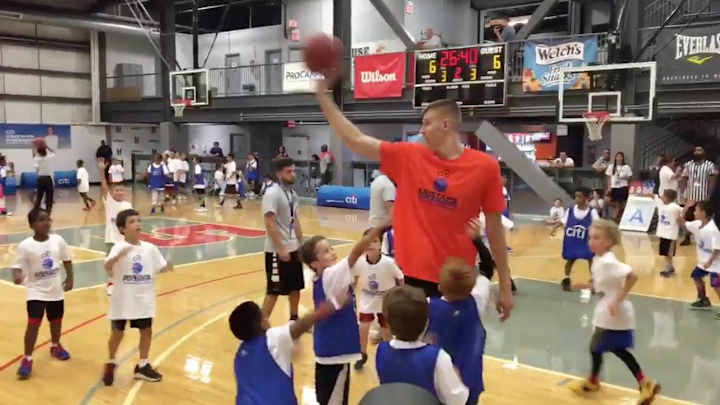 Let’s watch Kristaps Porzingis play basketball with kids half his size, on a rim as tall as he is