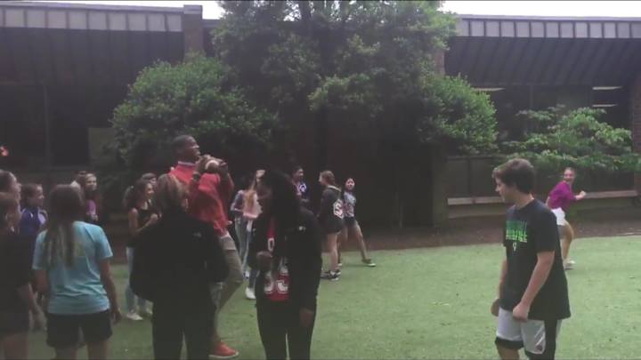 Cam Newton passes by school, hops fence to play football with kids Cam Newton passes by school, hops fence to play football with kids