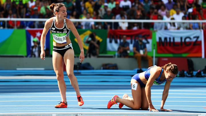 USA’s Abbey D’Agostino, opponent help each other to their feet after fall