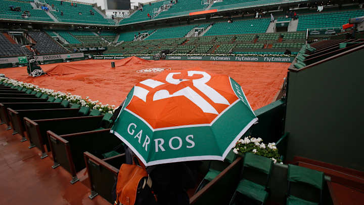 The Latest: Tarps back on all courts at French Open