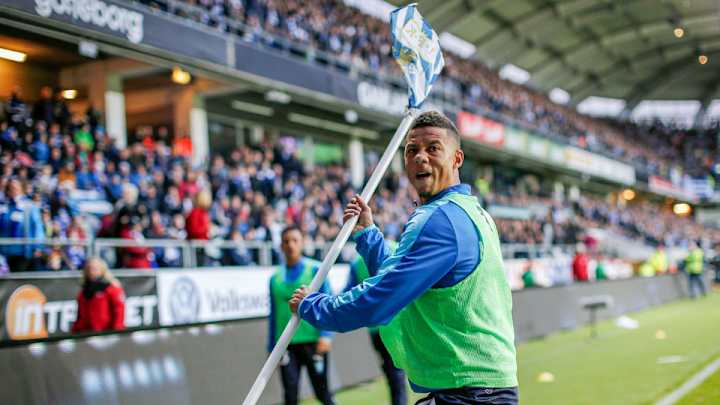 Watch: Fans throw firecracker at player; he throws corner flag at them