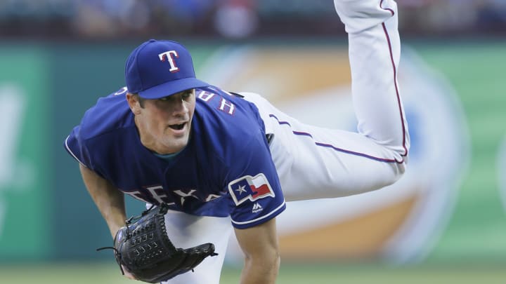 Hamels Ks 8 in 8th win for Rangers, 6-4 for split with Reds