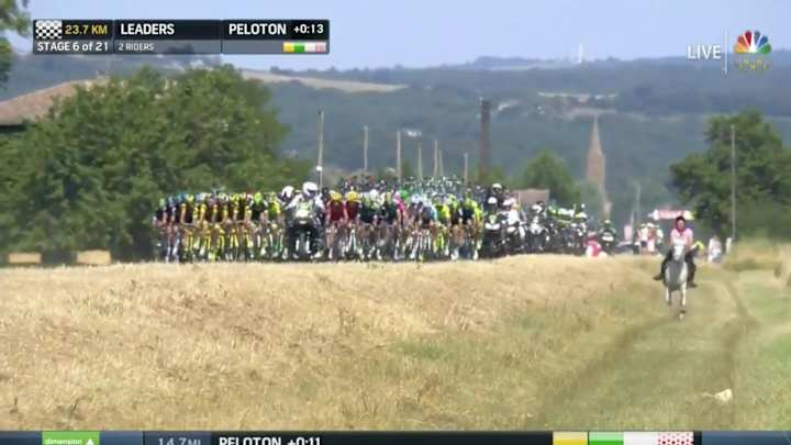 A woman rode a horse alongside a pack of cyclists at the Tour de France