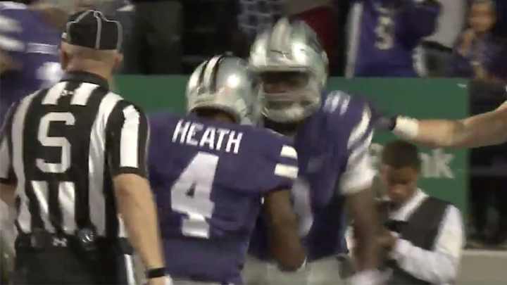 Kansas State player congratulates teammate on touchdown by punching him in the gut