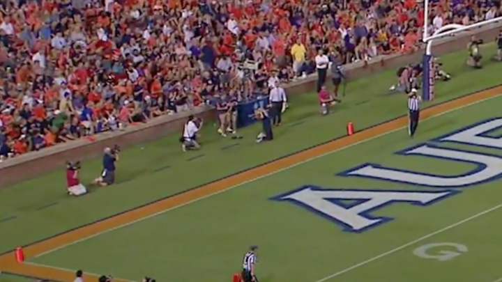 Photographer tries to catch football, gets hit right in the face