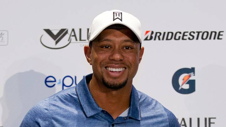 Woods has wild week: white Santa goatee, golf with Trump