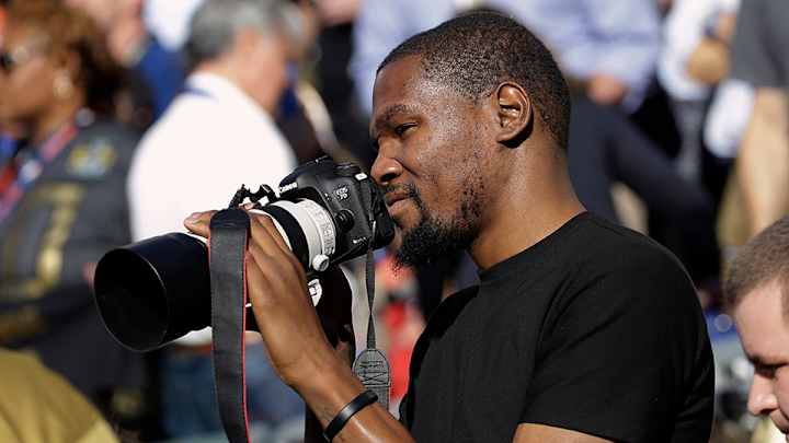 Kevin Durant photographing Super Bowl 50 from the sideline