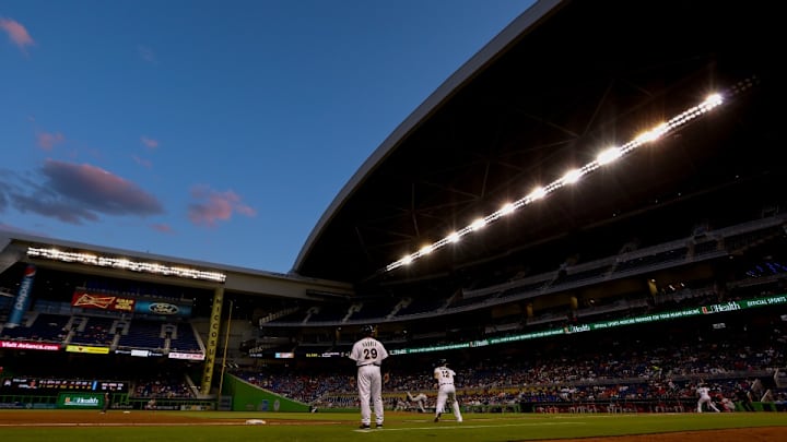Marlins fan makes backhanded grab while holding a child