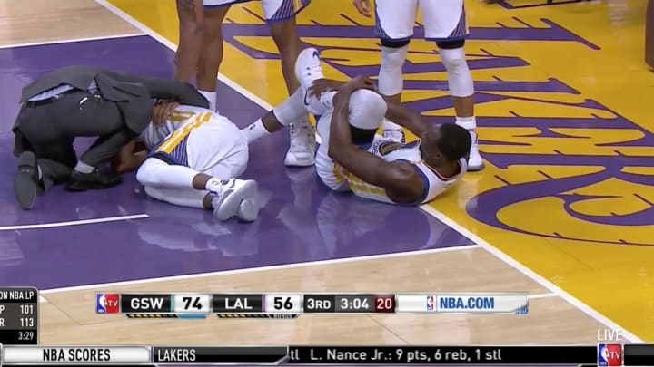 Draymond Green lands on teammate Ian Clark, sending both to the locker room with injuries