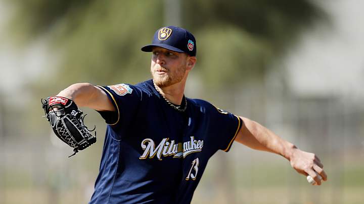 Brewers reliever tears knee ligament while taking shoes off