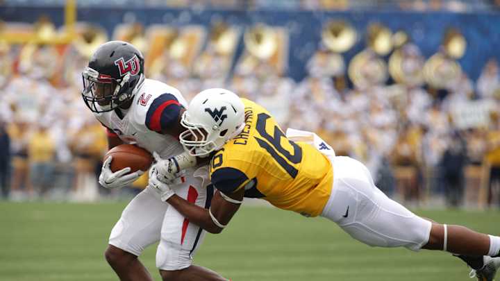 Howard's 3 TD tosses leads WVU over Liberty 41-17