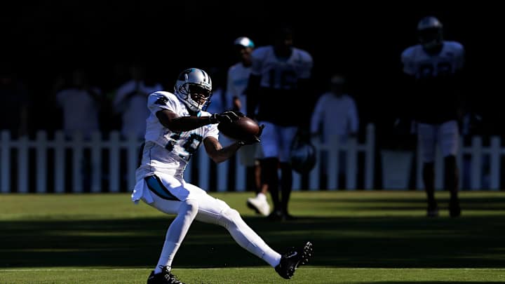 Ginn done 'chasing a check,' happy to return to Panthers