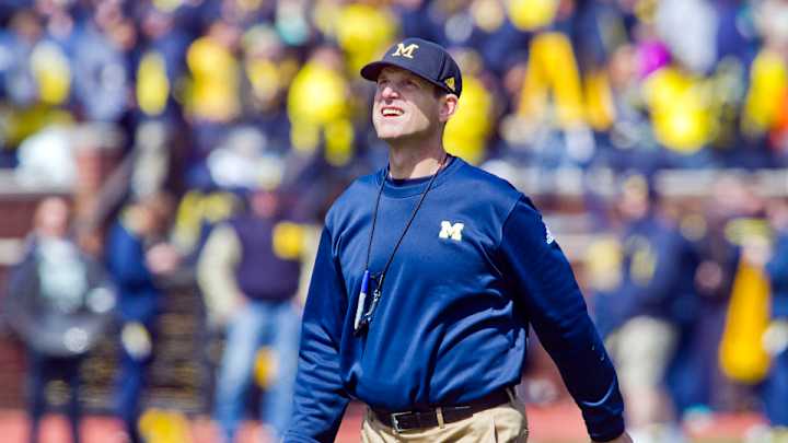 Michigan head coach Jim Harbaugh defends satellite camps
