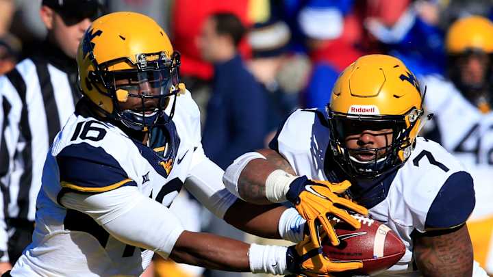 Mountaineers beat Kansas 49-0 to become eligible for bowl Mountaineers beat Kansas 49-0 to become eligible for bowl