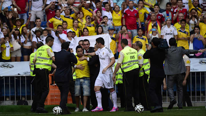 Fan invades pitch at James' unveiling; James saves him from security Fan invades pitch at James' unveiling; James saves him from security