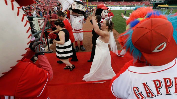 Couples say 'I do' on the grass at Great American Ball Park in Cincinnati Couples say 'I do' on the grass at Great American Ball Park in Cincinnati