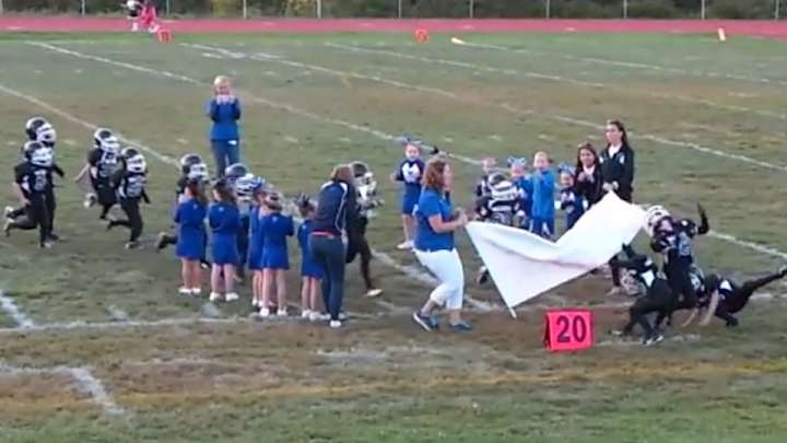 A banner brings an entire Mighty Mites football team to its knees A banner brings an entire Mighty Mites football team to its knees