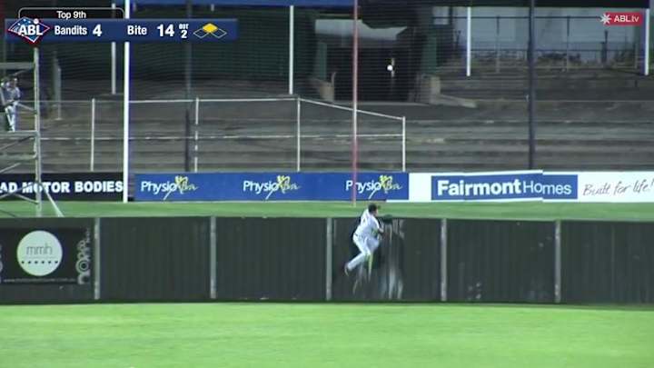 Australian Baseball League player destroys flimsy outfield wall