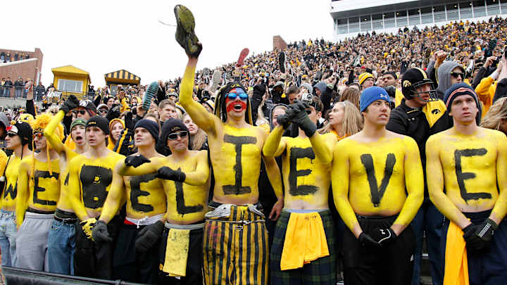 Iowa is paying tuition for five students who buy season football tickets