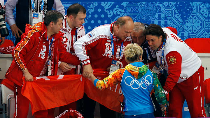 Communist party head shows banner at Sochi Games