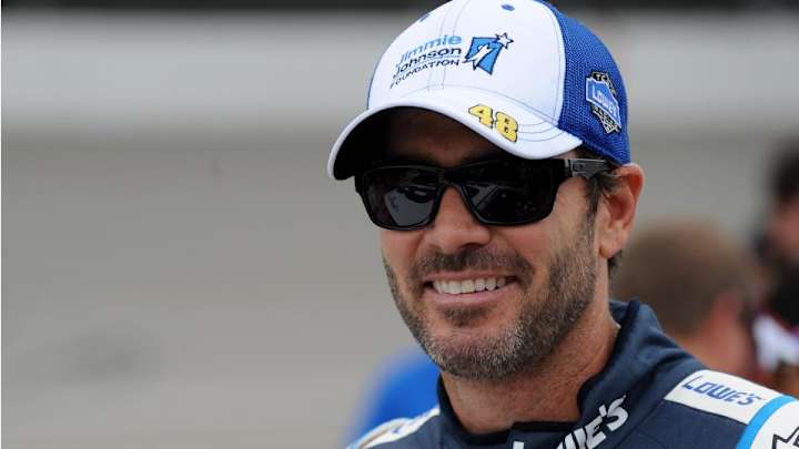 Driver Jimmie Johnson tries to shift with pliers