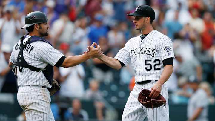 McKenry needs knee surgery, Rockies call up catcher Garneau