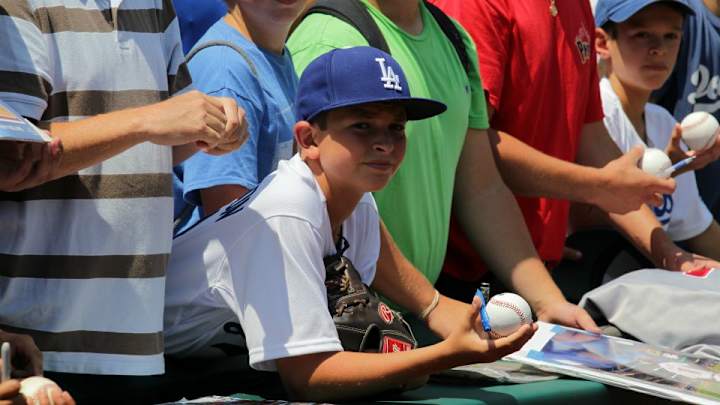 Young Dodgers fan gets handed foul ball, throws it away Young Dodgers fan gets handed foul ball, throws it away